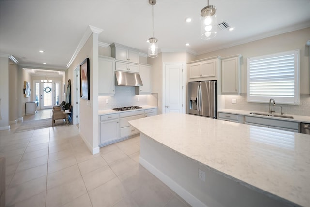 4735 Cassio Ct, Bradenton, FL 34211 - kitchen with stainless steel appliances, under cabinet range hood, ornamental molding, decorative backsplash, and light tile patterned floors