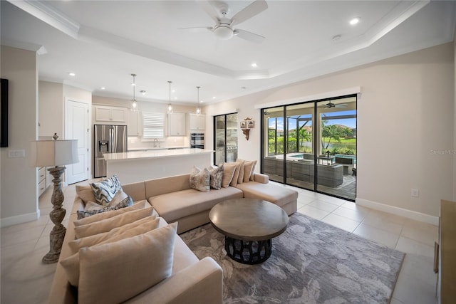 4735 Cassio Ct, Bradenton, FL 34211 - living room with ceiling fan, a raised ceiling, recessed lighting, light tile patterned floors, and crown molding