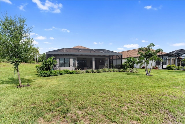 4735 Cassio Ct, Bradenton, FL 34211 - rear view of house featuring glass enclosure, a yard, and stucco siding