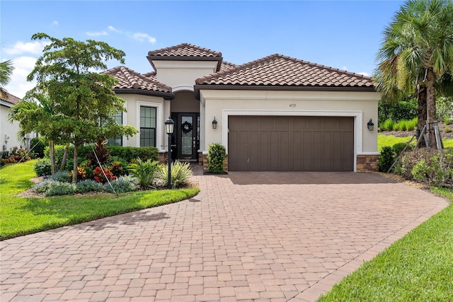 4735 Cassio Ct, Bradenton, FL 34211 - mediterranean / spanish house with decorative driveway, a garage, stucco siding, and a tile roof