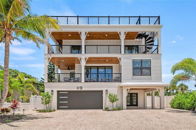 119 Avenida Messina, Sarasota, FL 34242 - view of front facade with a balcony, driveway, french doors, and a garage