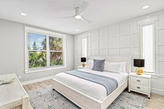119 Avenida Messina, Sarasota, FL 34242 - bedroom with a decorative wall, light wood-style floors, recessed lighting, and ceiling fan