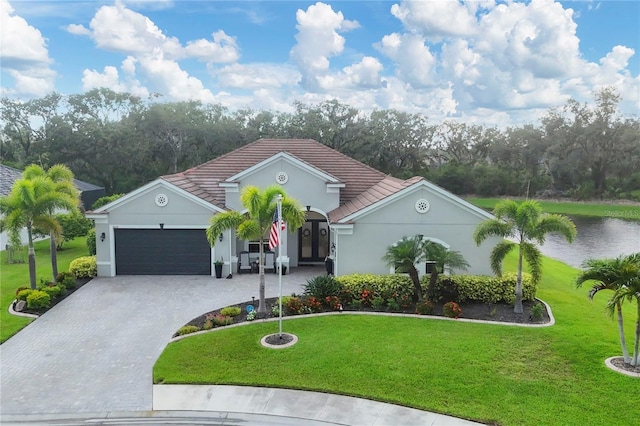 16038 39th Gln E, Parrish, FL 34219 - view of front of house with decorative driveway, an attached garage, a front lawn, and a tiled roof