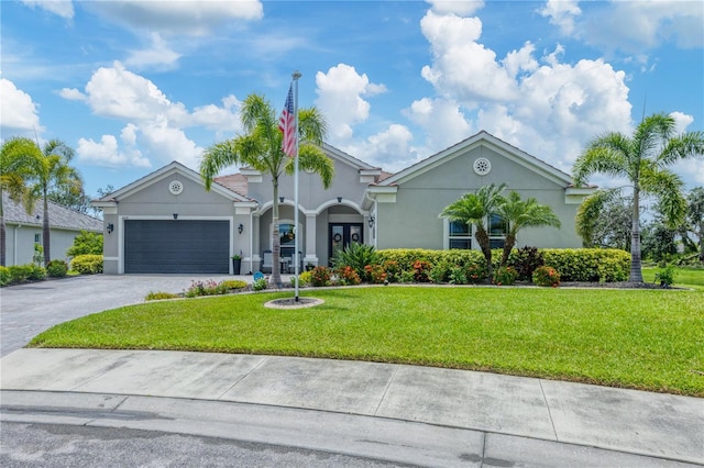16038 39th Gln E, Parrish, FL 34219 - view of front of house with driveway, stucco siding, a garage, and a front yard