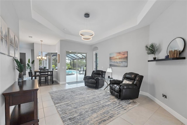 16038 39th Gln E, Parrish, FL 34219 - living area with a chandelier, a tray ceiling, and light tile patterned floors