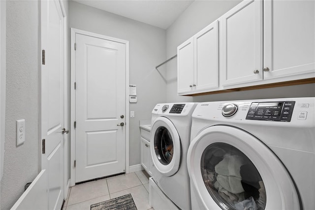 16038 39th Gln E, Parrish, FL 34219 - washroom featuring washer and clothes dryer, cabinet space, and light tile patterned floors