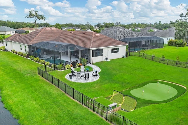 16038 39th Gln E, Parrish, FL 34219 - back of property featuring an area to practice putting, a fenced backyard, a tiled roof, a residential view, and a patio area