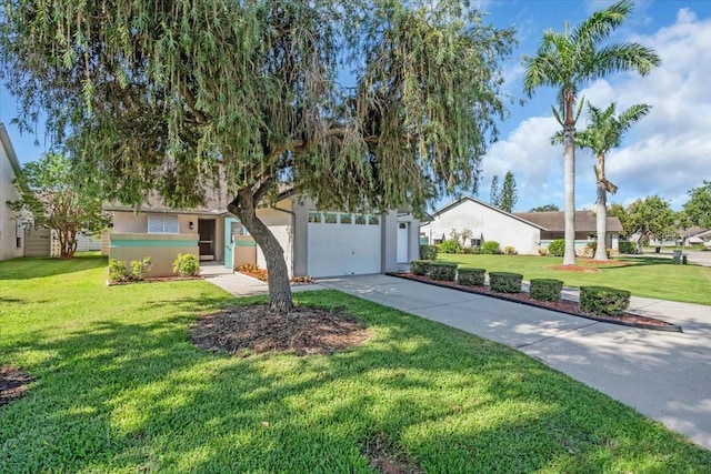 327 40th Ct W, Palmetto, FL 34221 - view of front facade with concrete driveway, a front yard, stucco siding, and a garage