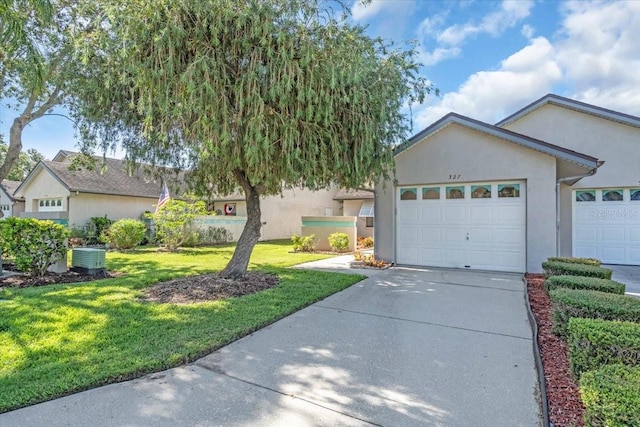327 40th Ct W, Palmetto, FL 34221 - ranch-style house with stucco siding, a front yard, concrete driveway, and an attached garage