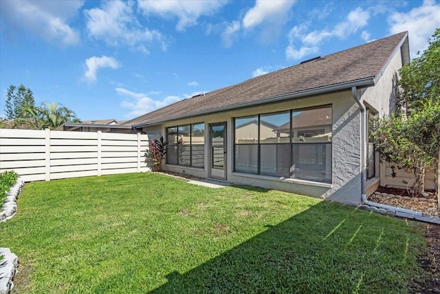 327 40th Ct W, Palmetto, FL 34221 - back of property featuring a fenced backyard, roof with shingles, and stucco siding
