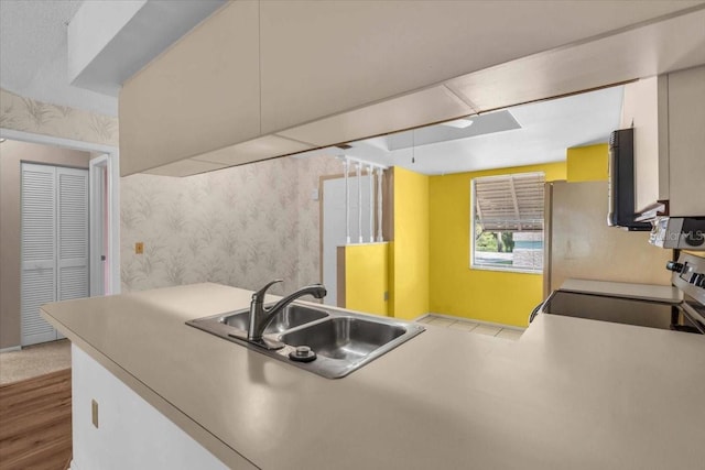 327 40th Ct W, Palmetto, FL 34221 - kitchen featuring wallpapered walls, wood finished floors, and stove