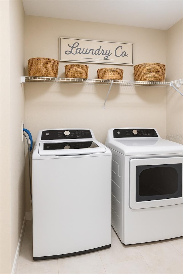 4140 Central Sarasota Pkwy Unit 1235, Sarasota, FL 34238 - washroom with washer and clothes dryer and light tile patterned floors