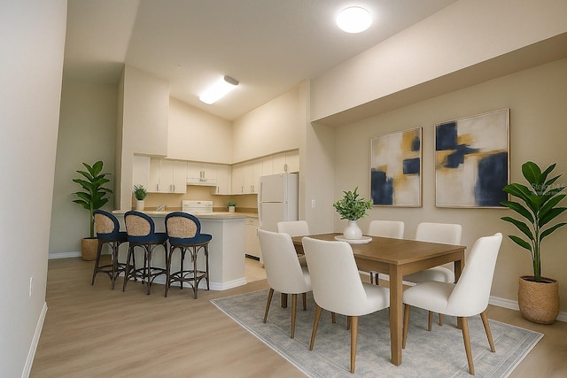 4140 Central Sarasota Pkwy Unit 1235, Sarasota, FL 34238 - dining room with light wood-style floors and high vaulted ceiling