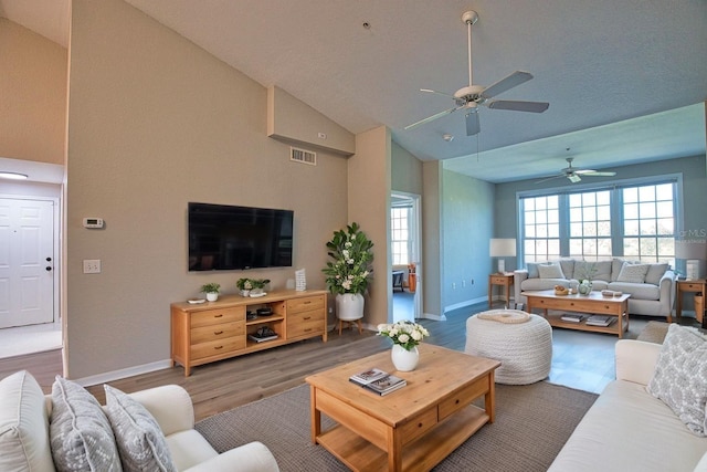4140 Central Sarasota Pkwy Unit 1235, Sarasota, FL 34238 - living room featuring a ceiling fan, wood finished floors, and high vaulted ceiling