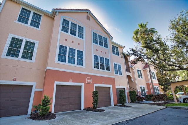 4140 Central Sarasota Pkwy Unit 1235, Sarasota, FL 34238 - view of front of property featuring stucco siding, driveway, and a garage