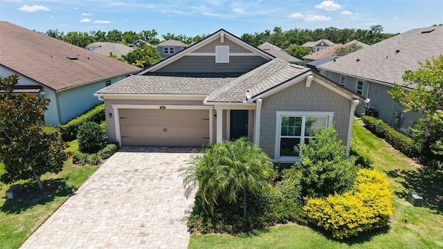 11223 Spring Gate Trl, Bradenton, FL 34211 - view of front of house with an attached garage, a shingled roof, and driveway