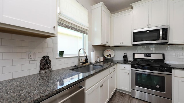 11223 Spring Gate Trl, Bradenton, FL 34211 - kitchen featuring appliances with stainless steel finishes, white cabinets, dark wood-style floors, and decorative backsplash