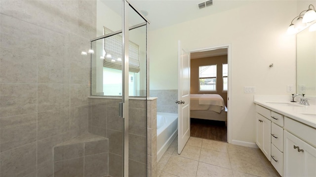 11223 Spring Gate Trl, Bradenton, FL 34211 - ensuite bathroom featuring double vanity, a bath, a shower stall, and tile patterned floors