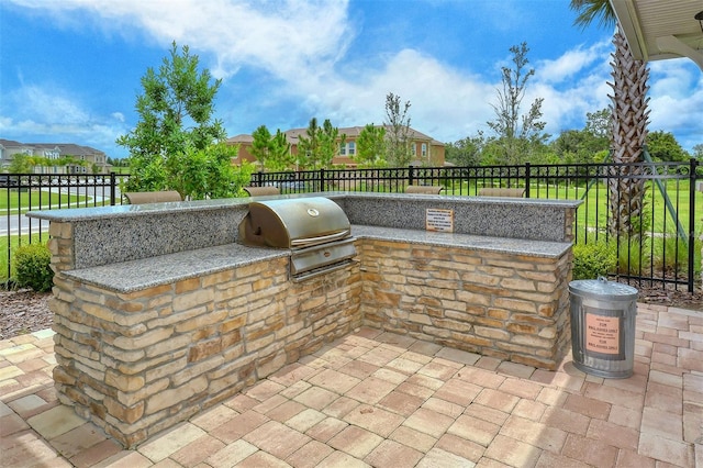 11223 Spring Gate Trl, Bradenton, FL 34211 - view of patio with an outdoor kitchen and a residential view