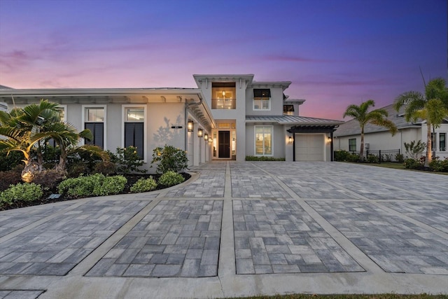 676 Regatta Way, Bradenton, FL 34208 - view of front of house with decorative driveway, stucco siding, a garage, a standing seam roof, and a metal roof