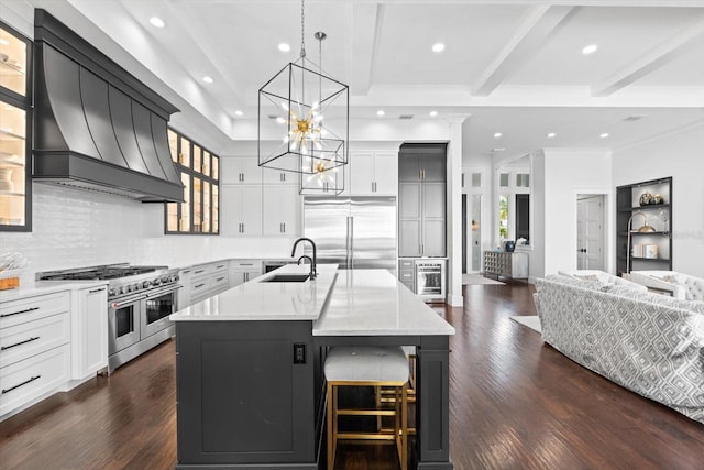 676 Regatta Way, Bradenton, FL 34208 - kitchen featuring high end appliances, custom exhaust hood, healthy amount of natural light, recessed lighting, and backsplash