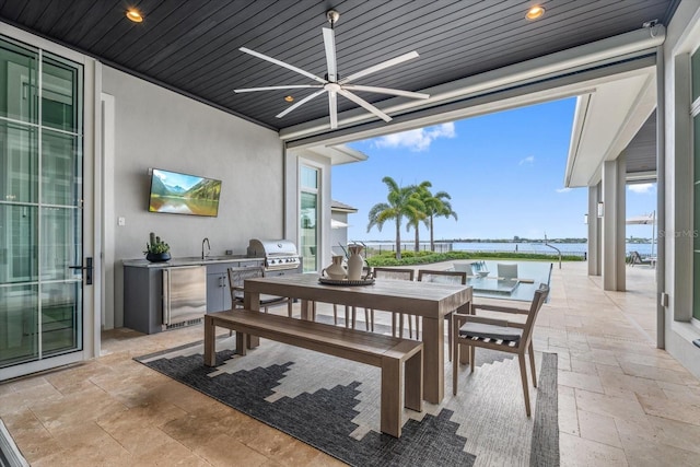 676 Regatta Way, Bradenton, FL 34208 - view of patio with an outdoor kitchen, a ceiling fan, and outdoor dining space