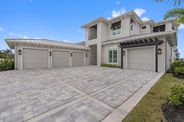676 Regatta Way, Bradenton, FL 34208 - view of property with a standing seam roof, decorative driveway, stucco siding, and a metal roof
