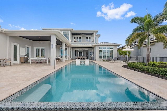 676 Regatta Way, Bradenton, FL 34208 - rear view of house featuring ceiling fan, a patio area, a balcony, and an outdoor pool