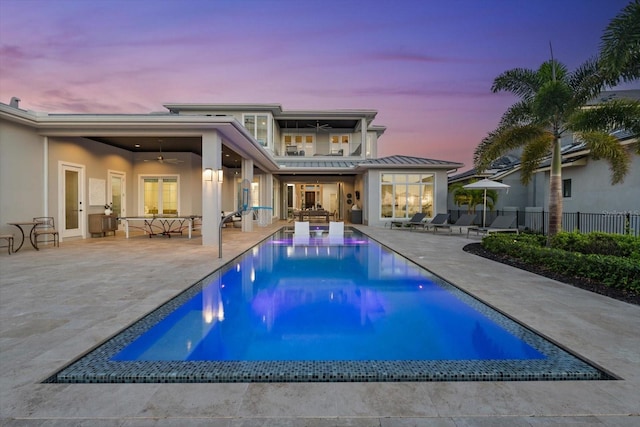 676 Regatta Way, Bradenton, FL 34208 - rear view of house featuring a ceiling fan, a balcony, an outdoor hangout area, stucco siding, and a standing seam roof