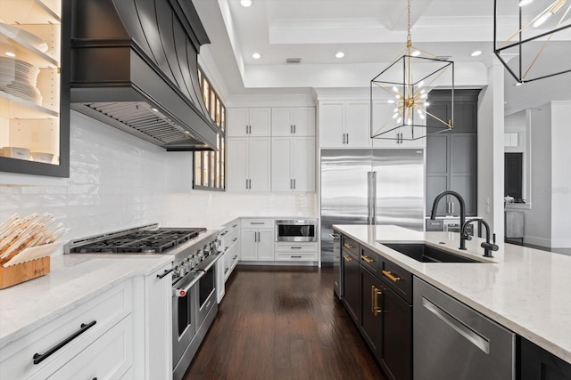 676 Regatta Way, Bradenton, FL 34208 - kitchen with premium appliances, recessed lighting, light stone countertops, a chandelier, and backsplash