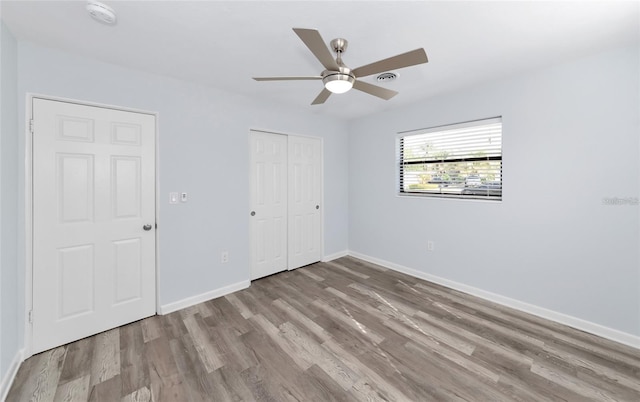 4505 18th Ave W, Bradenton, FL 34209 - unfurnished bedroom featuring wood finished floors, a closet, and ceiling fan