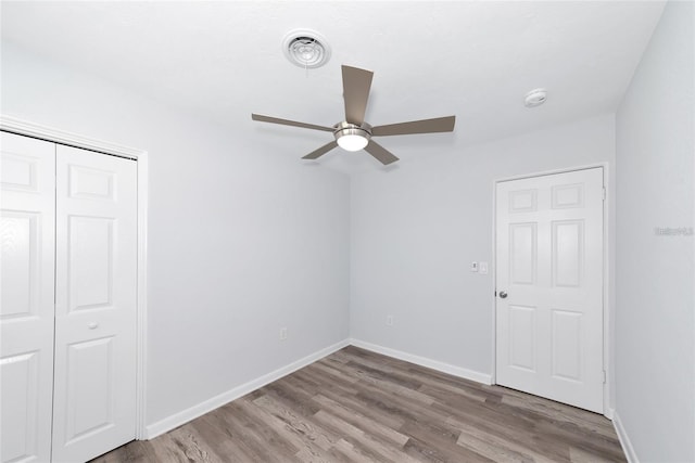 4505 18th Ave W, Bradenton, FL 34209 - unfurnished bedroom with wood finished floors, a closet, and ceiling fan