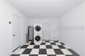 4505 18th Ave W, Bradenton, FL 34209 - laundry area with stacked washer and clothes dryer and tile patterned floors
