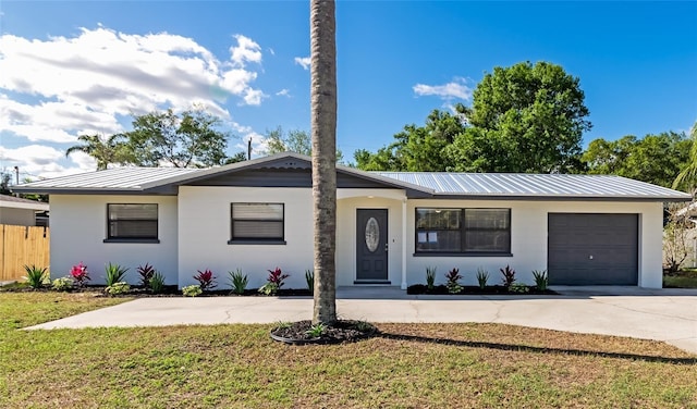 4505 18th Ave W, Bradenton, FL 34209 - ranch-style home with a metal roof, driveway, an attached garage, and stucco siding