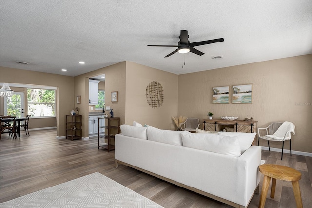 616 59th St NW, Bradenton, FL 34209 - living room featuring wood finished floors, ceiling fan, a textured ceiling, and recessed lighting