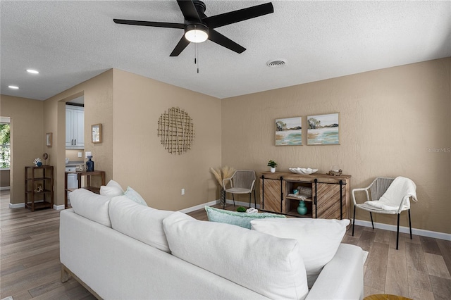 616 59th St NW, Bradenton, FL 34209 - living area with wood finished floors, a textured ceiling, ceiling fan, and recessed lighting