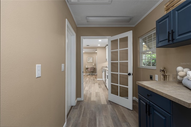 616 59th St NW, Bradenton, FL 34209 - corridor featuring french doors, wood finished floors, and ornamental molding