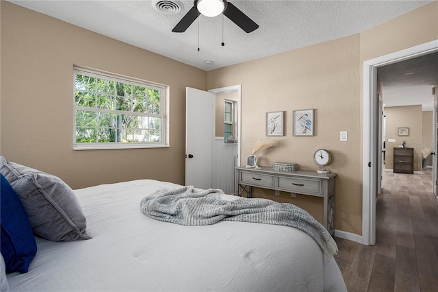 616 59th St NW, Bradenton, FL 34209 - bedroom featuring wood-type flooring, ceiling fan, and a textured wall