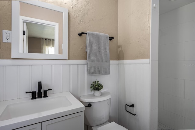 616 59th St NW, Bradenton, FL 34209 - bathroom featuring vanity, wainscoting, and a textured wall