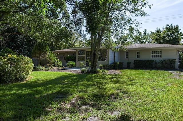 616 59th St NW, Bradenton, FL 34209 - rear view of property with a lawn