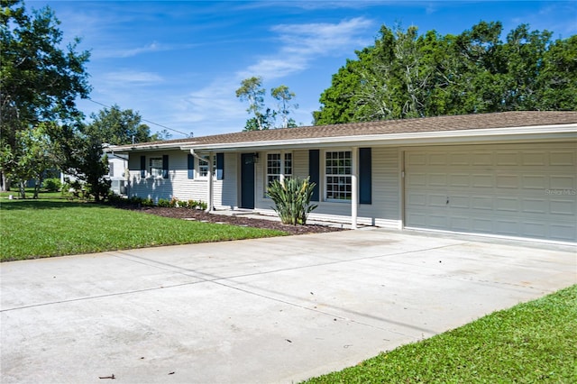 616 59th St NW, Bradenton, FL 34209 - single story home featuring an attached garage, driveway, covered porch, and a front yard