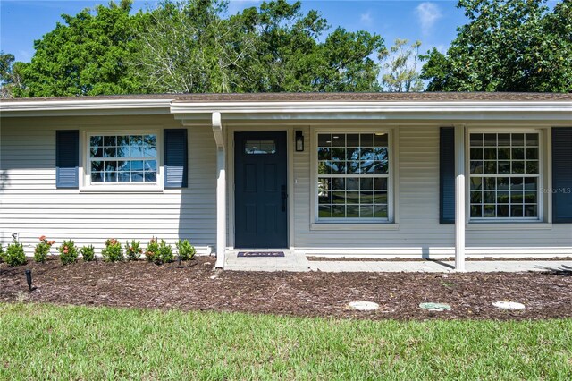 616 59th St NW, Bradenton, FL 34209 - view of front facade featuring covered porch and a shingled roof