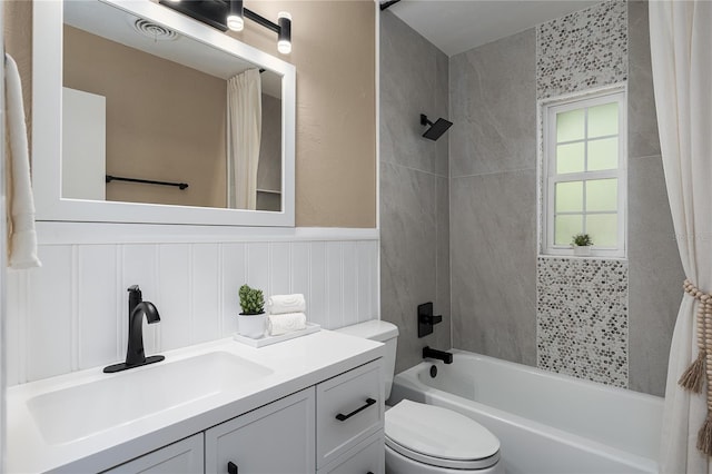 616 59th St NW, Bradenton, FL 34209 - bathroom featuring shower / bath combo with shower curtain, vanity, a wainscoted wall, and a decorative wall