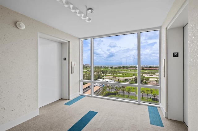 2425 Gulf Of Mexico Dr Unit 10F, Longboat Key, FL 34228 - carpeted empty room featuring a wall of windows and elevator