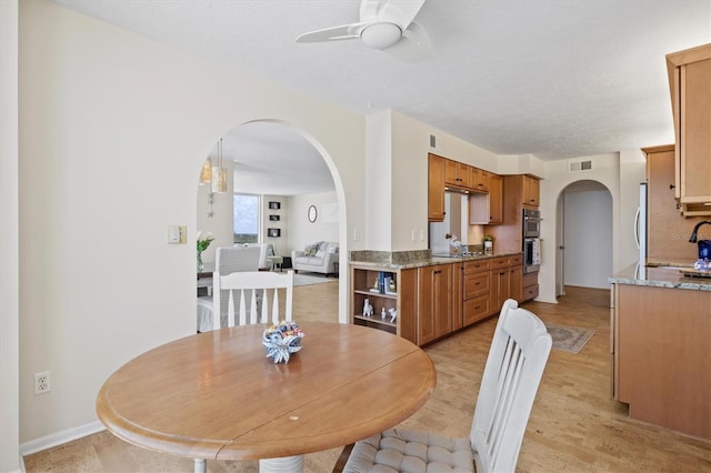 2425 Gulf Of Mexico Dr Unit 10F, Longboat Key, FL 34228 - dining area featuring arched walkways and ceiling fan