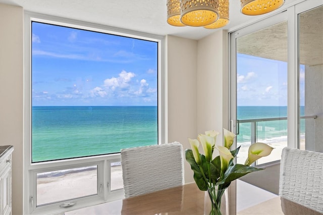 2425 Gulf Of Mexico Dr Unit 10F, Longboat Key, FL 34228 - dining room featuring a water view and expansive windows