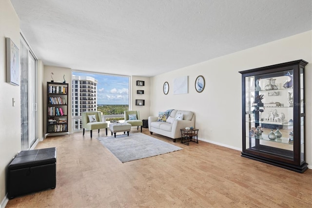 2425 Gulf Of Mexico Dr Unit 10F, Longboat Key, FL 34228 - living area with a textured ceiling and baseboards