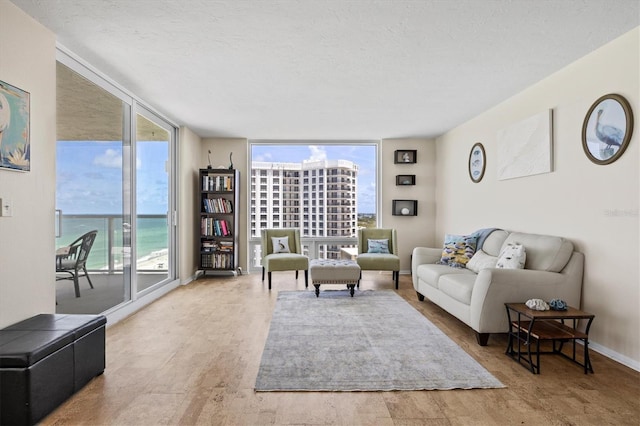 2425 Gulf Of Mexico Dr Unit 10F, Longboat Key, FL 34228 - living area with expansive windows, healthy amount of natural light, and a textured ceiling