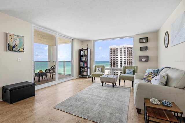 2425 Gulf Of Mexico Dr Unit 10F, Longboat Key, FL 34228 - living room with a water view, wood finished floors, and floor to ceiling windows