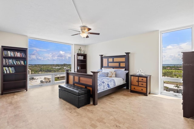 2425 Gulf Of Mexico Dr Unit 10F, Longboat Key, FL 34228 - bedroom featuring a wall of windows, multiple windows, ceiling fan, and access to outside